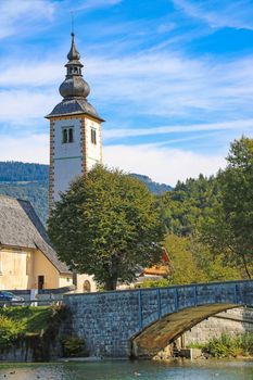 Church of St. John the Baptist and a bridge by the Bohinj lake, Slovenia