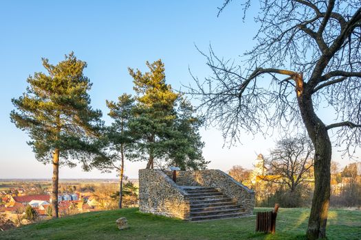 Pichora Marcomanni burial ground south of Dobrichov in the Kolin region Czech republic. Archaeological excavations With small lookout tower near the pine trees with wiew to small city Dobrichov.