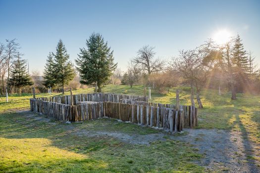 Pichora Marcomanni burial ground south of Dobrichov in the Kolin region Czech republic. Archaeological excavations With small lookout tower near the pine trees with wiew to small city Dobrichov.