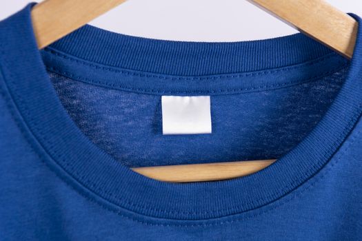 Mockup blank blue t-shirt and blank label tag for advertising.