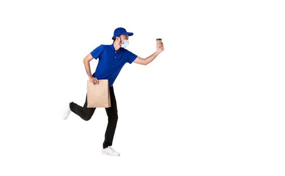 Asian delivery man wearing face mask in blue uniform running with paper bag and takeaway coffee isolated over white background. express delivery service during covid19.