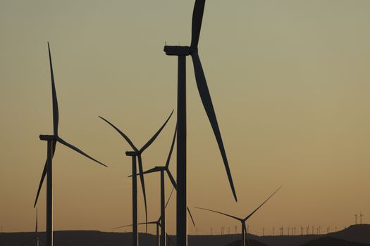 Silhouettes of wind turbines at sunset in the Ribera Alta del Ebro region, in Aragon, Spain.