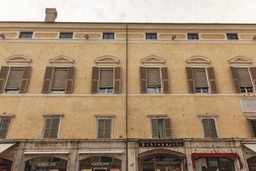 FERRARA, ITALY 29 JULY 2020 : Ancient building with many windows in Ferrara in Italy