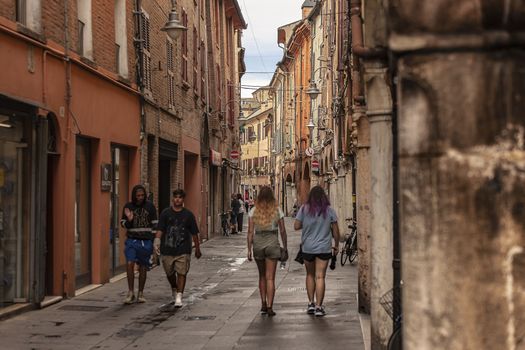 FERRARA, ITALY 29 JULY 2020 : Alley of Ferrara in Italy full of people walking