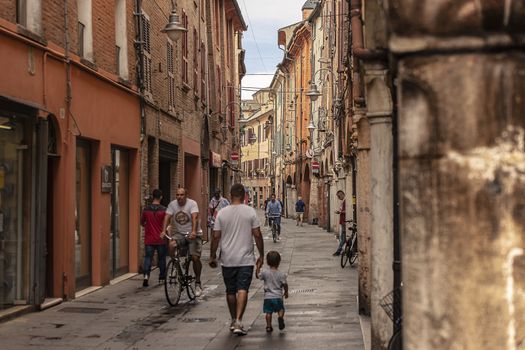 FERRARA, ITALY 29 JULY 2020 : Alley of Ferrara in Italy full of people walking