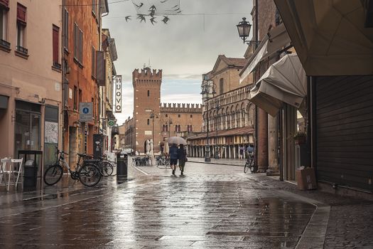 FERRARA, ITALY 29 JULY 2020 : Ferrara alley with a view of the castle and the main square