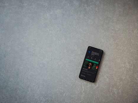 Lod, Israel - July 8, 2020: Adobe Lightroom - Photo Editor and Pro Camera app play store page on the display of a black mobile smartphone on ceramic stone background. Top view flat lay with copy space.