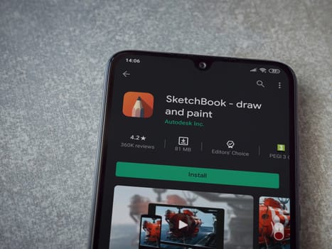 Lod, Israel - July 8, 2020: Autodesk SketchBook - draw and paint app play store page on the display of a black mobile smartphone on ceramic stone background. Top view flat lay with copy space.