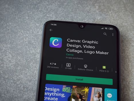 Lod, Israel - July 8, 2020: Canva - Graphic Design app play store page on the display of a black mobile smartphone on ceramic stone background. Top view flat lay with copy space. 