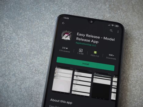 Lod, Israel - July 8, 2020: Easy Release Pro - Model Release app play store page on the display of a black mobile smartphone on ceramic stone background. Top view flat lay with copy space. 