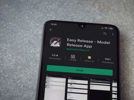 Lod, Israel - July 8, 2020: Easy Release Pro - Model Release app play store page on the display of a black mobile smartphone on ceramic stone background. Top view flat lay with copy space. 