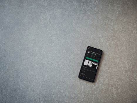 Lod, Israel - July 8, 2020: Easy Release Pro - Model Release app play store page on the display of a black mobile smartphone on ceramic stone background. Top view flat lay with copy space. 