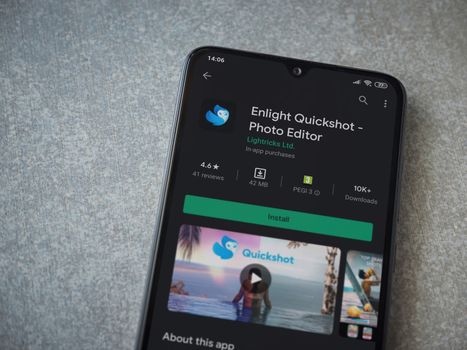Lod, Israel - July 8, 2020: Enlight Quickshot app play store page on the display of a black mobile smartphone on ceramic stone background. Top view flat lay with copy space.