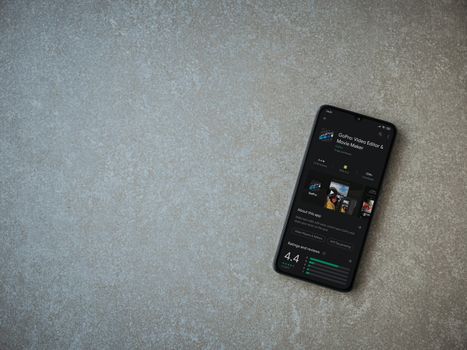 Lod, Israel - July 8, 2020: GoPro - Video Editor and Movie Maker app play store page on the display of a black mobile smartphone on ceramic stone background. Top view flat lay with copy space.