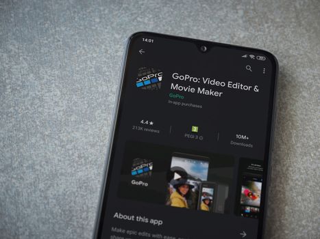 Lod, Israel - July 8, 2020: GoPro - Video Editor and Movie Maker app play store page on the display of a black mobile smartphone on ceramic stone background. Top view flat lay with copy space.