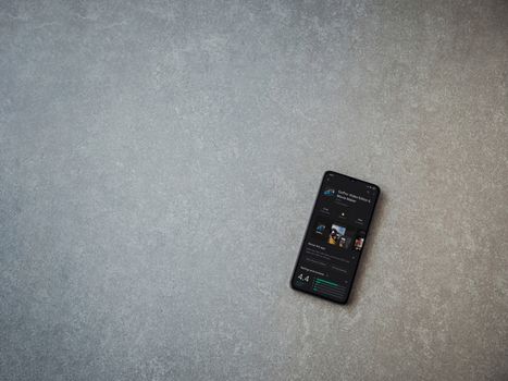 Lod, Israel - July 8, 2020: GoPro - Video Editor and Movie Maker app play store page on the display of a black mobile smartphone on ceramic stone background. Top view flat lay with copy space.