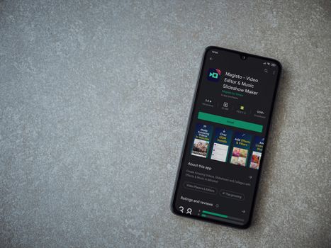 Lod, Israel - July 8, 2020: Magisto - Video Editor and Movie Maker app play store page on the display of a black mobile smartphone on ceramic stone background. Top view flat lay with copy space.