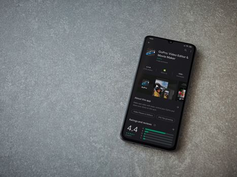 Lod, Israel - July 8, 2020: GoPro - Video Editor and Movie Maker app play store page on the display of a black mobile smartphone on ceramic stone background. Top view flat lay with copy space.