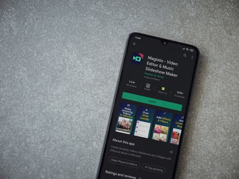 Lod, Israel - July 8, 2020: Magisto - Video Editor and Movie Maker app play store page on the display of a black mobile smartphone on ceramic stone background. Top view flat lay with copy space.