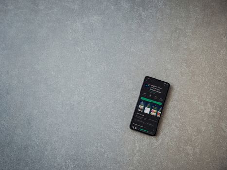 Lod, Israel - July 8, 2020: Magisto - Video Editor and Movie Maker app play store page on the display of a black mobile smartphone on ceramic stone background. Top view flat lay with copy space.