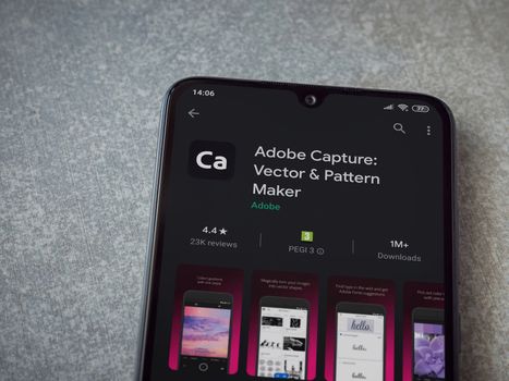 Lod, Israel - July 8, 2020: Adobe Capture - Vector and Pattern Maker app play store page on the display of a black mobile smartphone on ceramic stone background. Top view flat lay with copy space.
