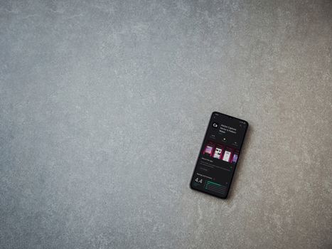 Lod, Israel - July 8, 2020: Adobe Capture - Vector and Pattern Maker app play store page on the display of a black mobile smartphone on ceramic stone background. Top view flat lay with copy space.