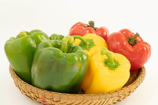 Green, yellow, red bell peppers placed in a seedling for nutritious cooking.