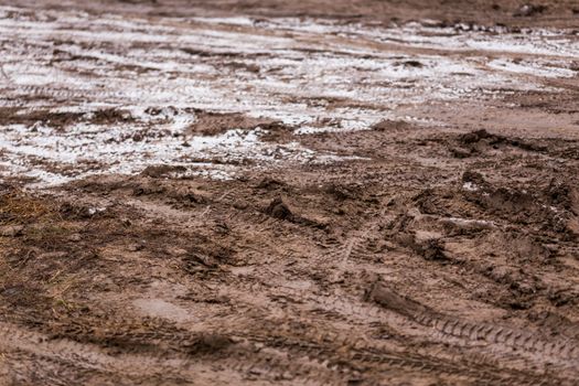 dirty mud road background at winter with selective focus and blur ft loudy weather