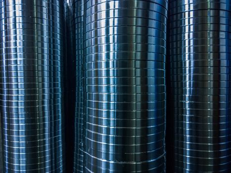 industrial manufacturing background of columns of shiny metal rings after cnc turning operation. Selective focus technique.