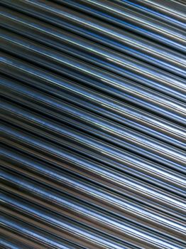 abstract industrial background of shiny cnc turned rods with flat lay in simple diagonal geometric composition