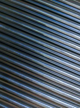 abstract industrial background of shiny cnc turned rods with flat lay in simple diagonal geometric composition