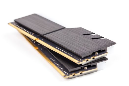 a pair of ddr4 dimm pc ram memoty modules with stylish black heatsinks - isolated on white with selective focus.
