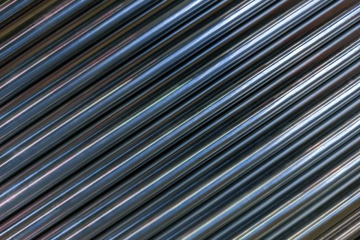 abstract industrial background of shiny cnc turned rods with flat lay in simple diagonal geometric composition