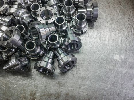 Shiny steel parts after cnc turning, drilling and machining on steel surface selective focus composition background.