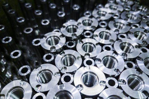 Shiny steel parts close-up background, long clean steel rods after fine cnc turning.