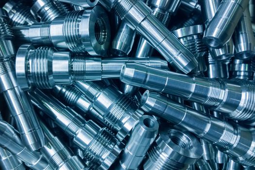 shiny steel parts background, a pile of long steel rods after modern fine cnc turning cut.