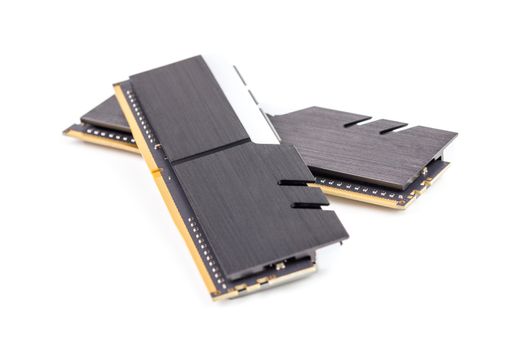 a pair of ddr4 dimm pc ram memoty modules with stylish black heatsinks - isolated on white with selective focus.