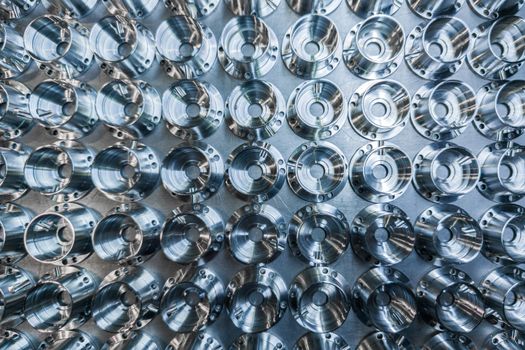 a batch of shiny metal cnc aerospace parts production - close-up flat lay with selective focus for industrial background in flat lay composition