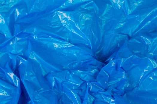 crumpled blue polyethilene film abstract background with selective focus.
