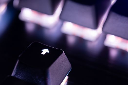 a close-up view of black mechanical pc keyboard with white backlight.