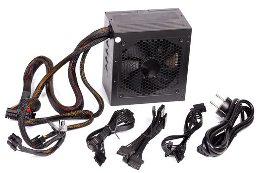 pc atx half-modular power supply isolated on white background with selective focus.