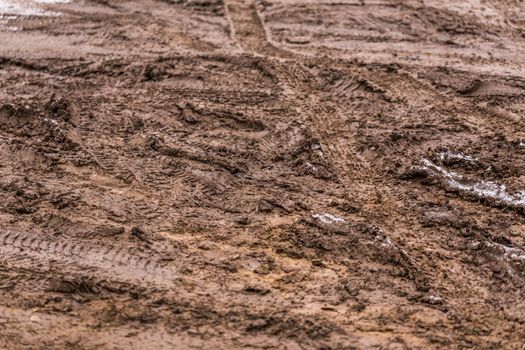 dirty mud road background at winter with selective focus and blur ft loudy weather