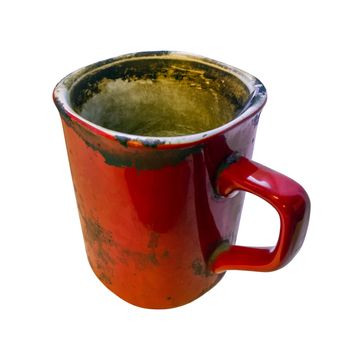 Disgusting super dirty red coffe empty mug isolated on white background with selective focus. Spoon included.