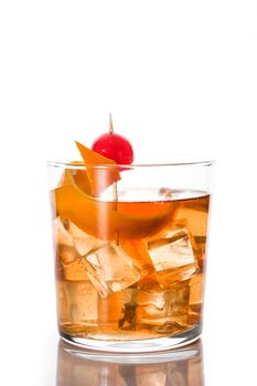 Old fashioned cocktail with orange and cherry isolated on white background