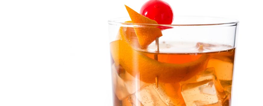 Old fashioned cocktail with orange and cherry isolated on white background