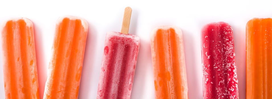 Orange and strawberry popsicles isolated on white background.