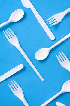 Disposable plastic tableware pattern on blue background