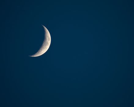 Telephoto view of the waxing crescent moon with the Sea of Tranquility (Mare Tranquillitatis) visible.