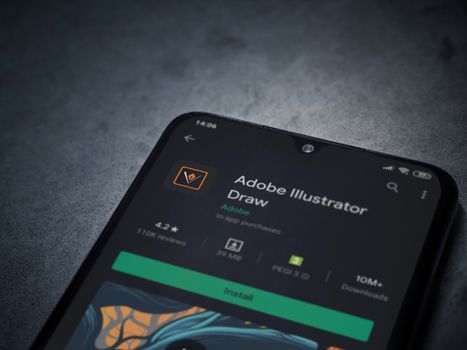Lod, Israel - July 8, 2020: Adobe Illustrator Draw app play store page on the display of a black mobile smartphone on a dark marble stone background. Top view flat lay with copy space.