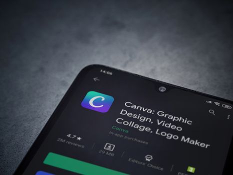 Lod, Israel - July 8, 2020: Canva - Graphic Design app play store page on the display of a black mobile smartphone on a dark marble stone background. Top view flat lay with copy space. 
